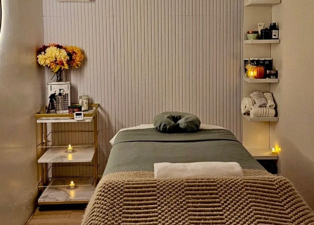 Relaxing massage room at Aura Sanctuary, New York, New York, US with cozy decor and ambient lighting.