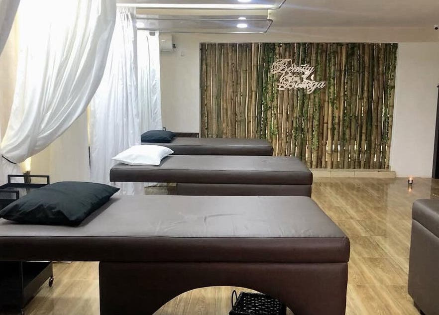 Relaxing spa beds at Beauty Bottega, Lekki, Lagos, NG, with a tranquil ambiance and bamboo decor.