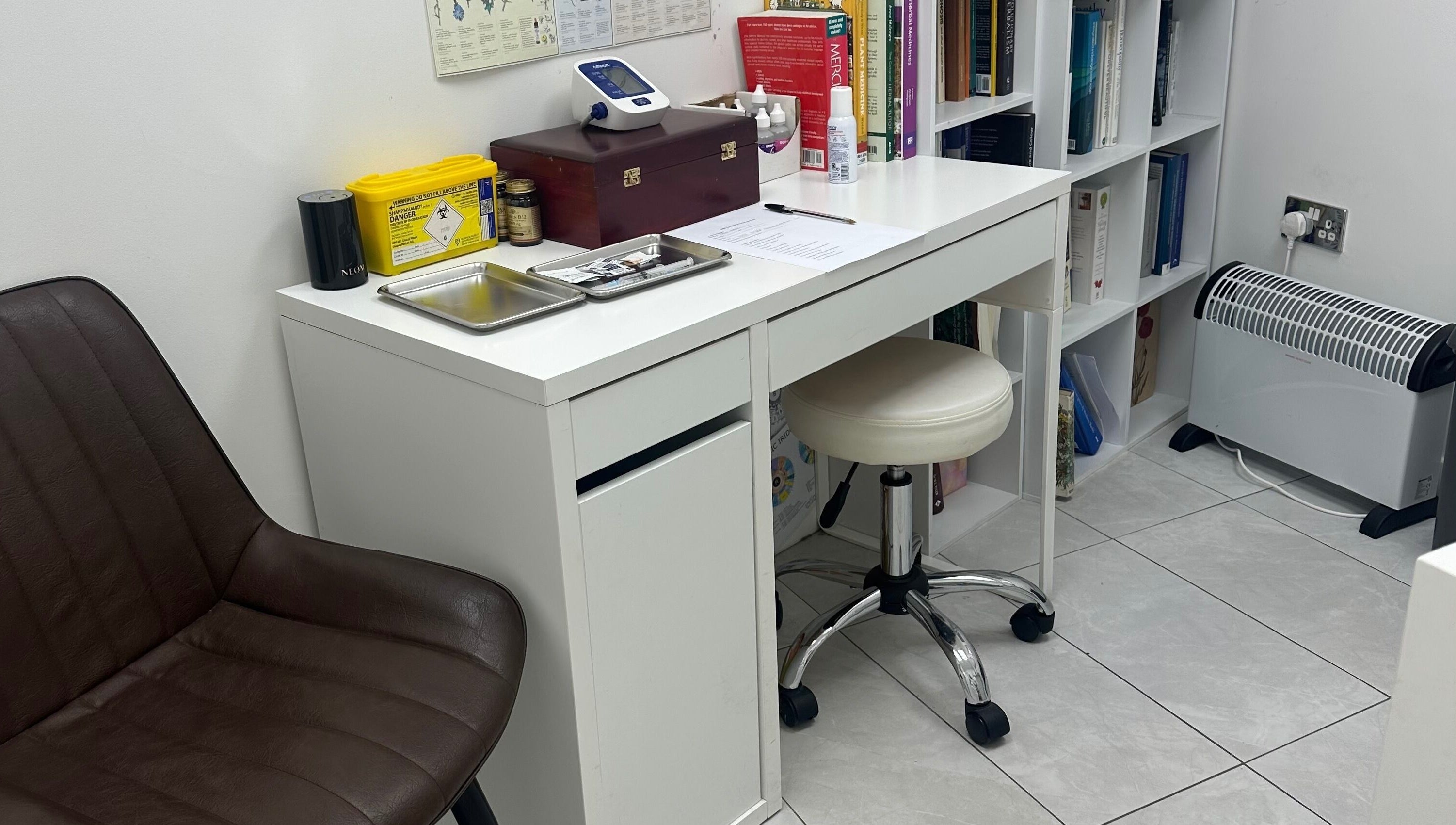 Clean treatment room at Wellness Space @ The Clinic, Glasgow, Scotland, GB with desk and chair.
