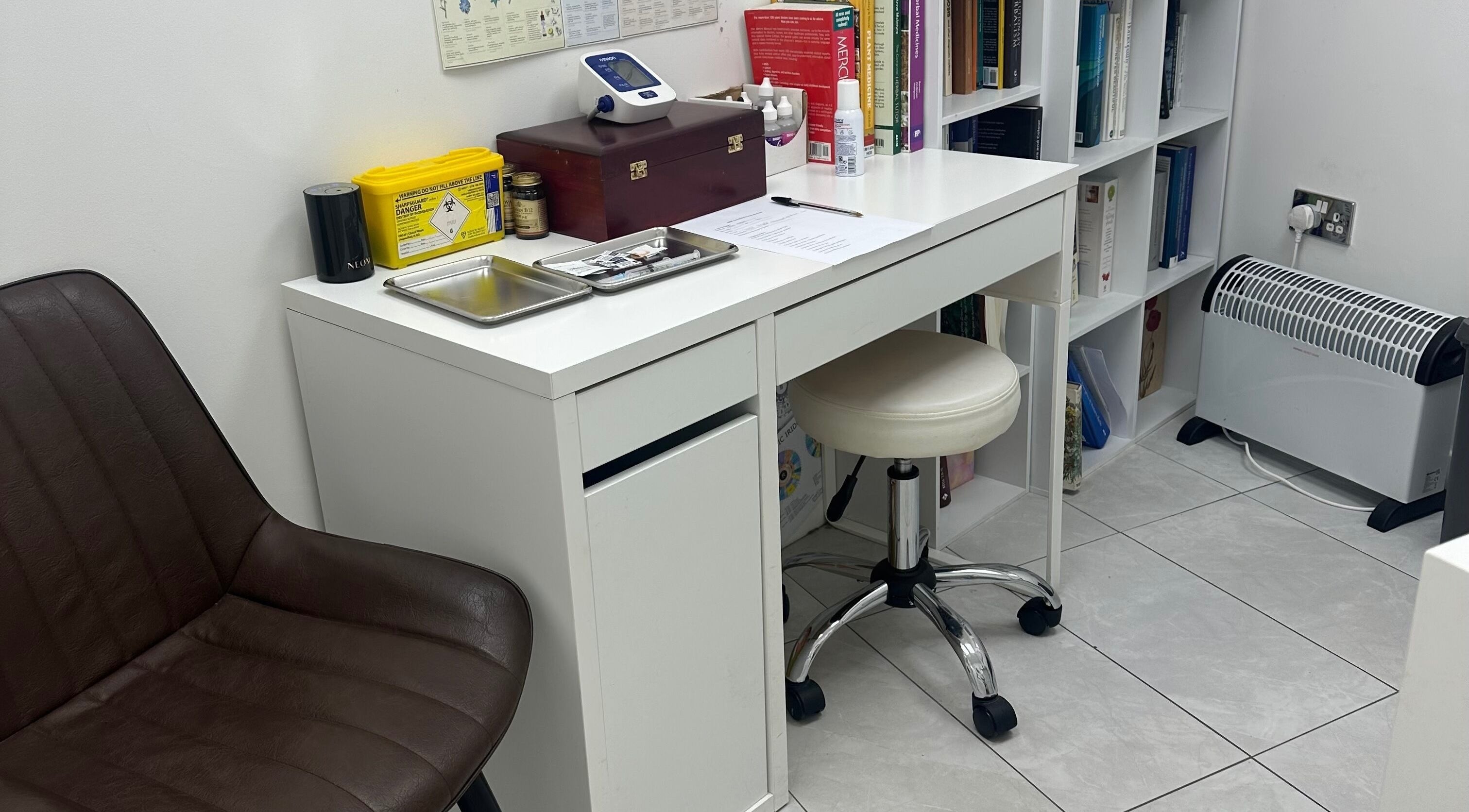 Clean treatment room at Wellness Space @ The Clinic, Glasgow, Scotland, GB with desk and chair.