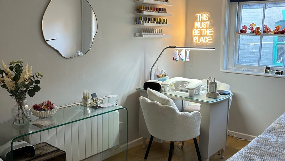 Elegant nail station at Ava Franklin Beauty Studios in Norwich, England, GB, with modern decor and neon sign.