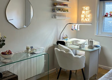 Elegant nail station at Ava Franklin Beauty Studios in Norwich, England, GB, with modern decor and neon sign.
