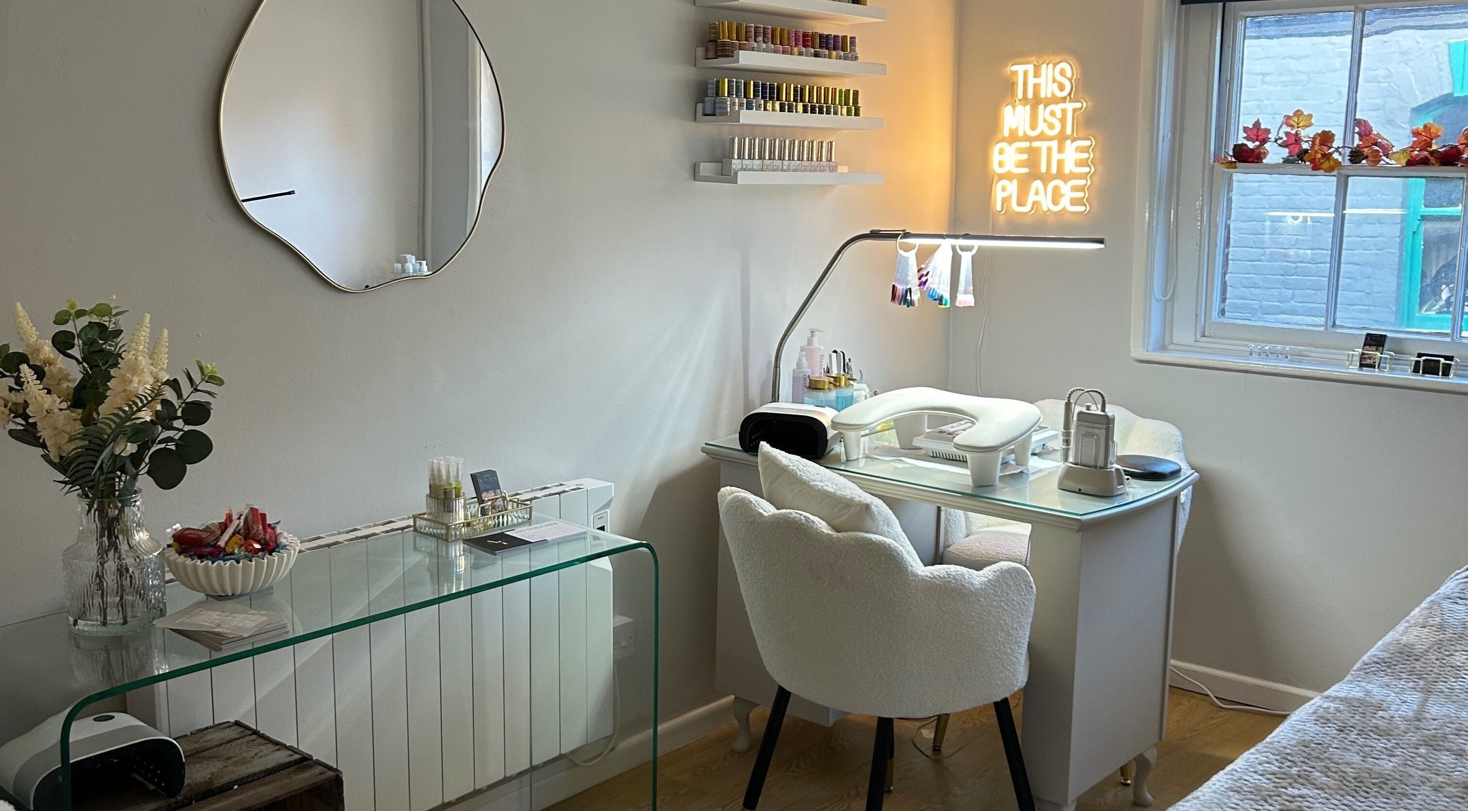 Elegant nail station at Ava Franklin Beauty Studios in Norwich, England, GB, with modern decor and neon sign.