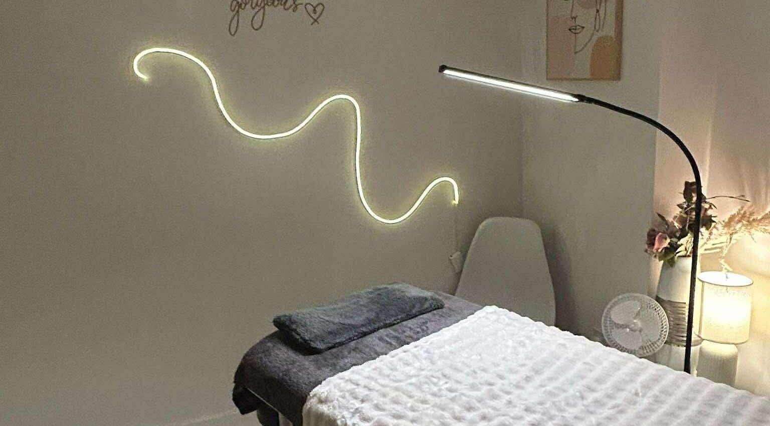 Relaxing treatment room at EvesEssence, Great Yarmouth, England, GB, with ambient lighting and a comfy table.