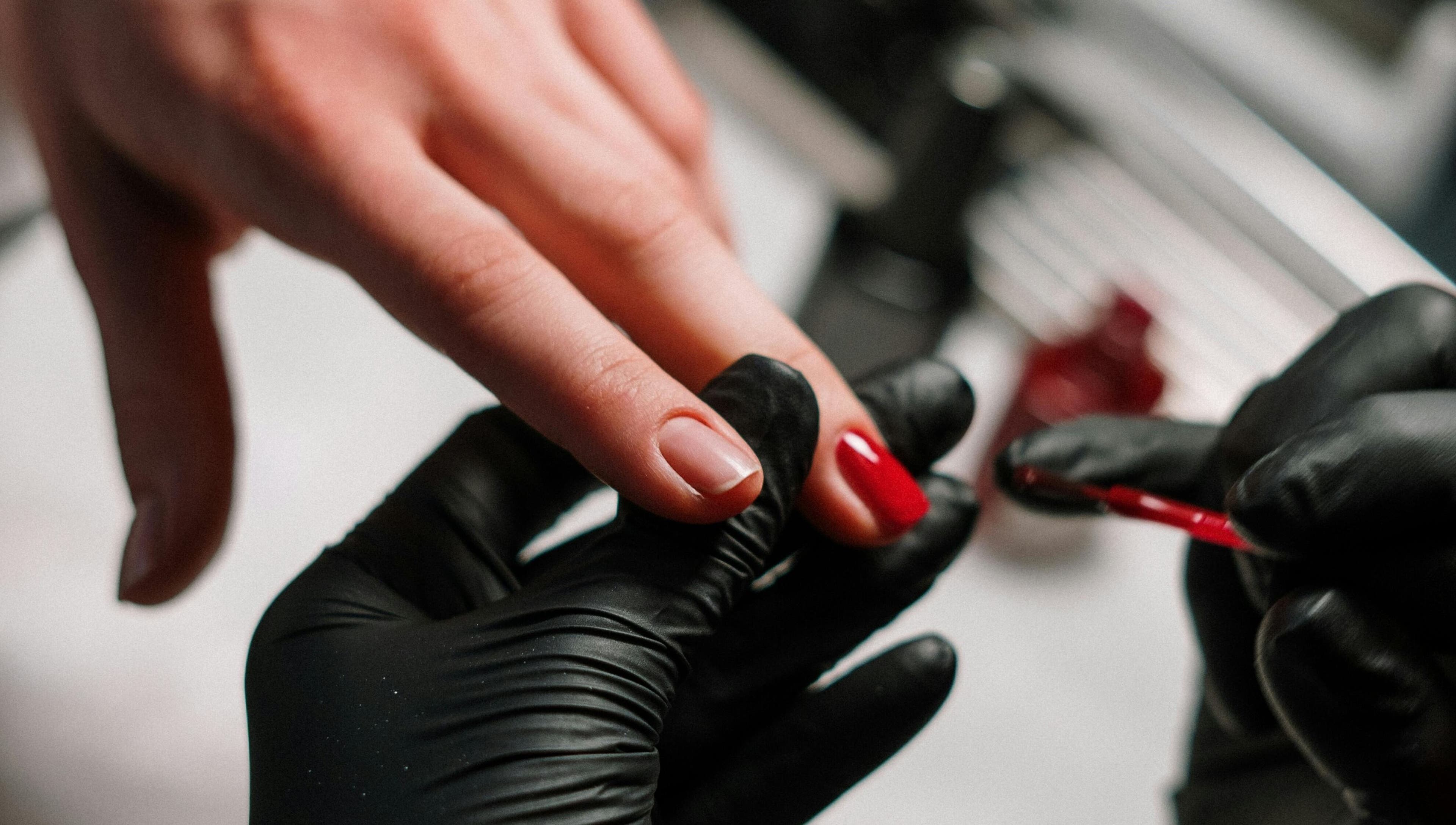 Luxurious manicure at Kulture Beauty Art in London, England, GB, showcasing red nail polish application.
