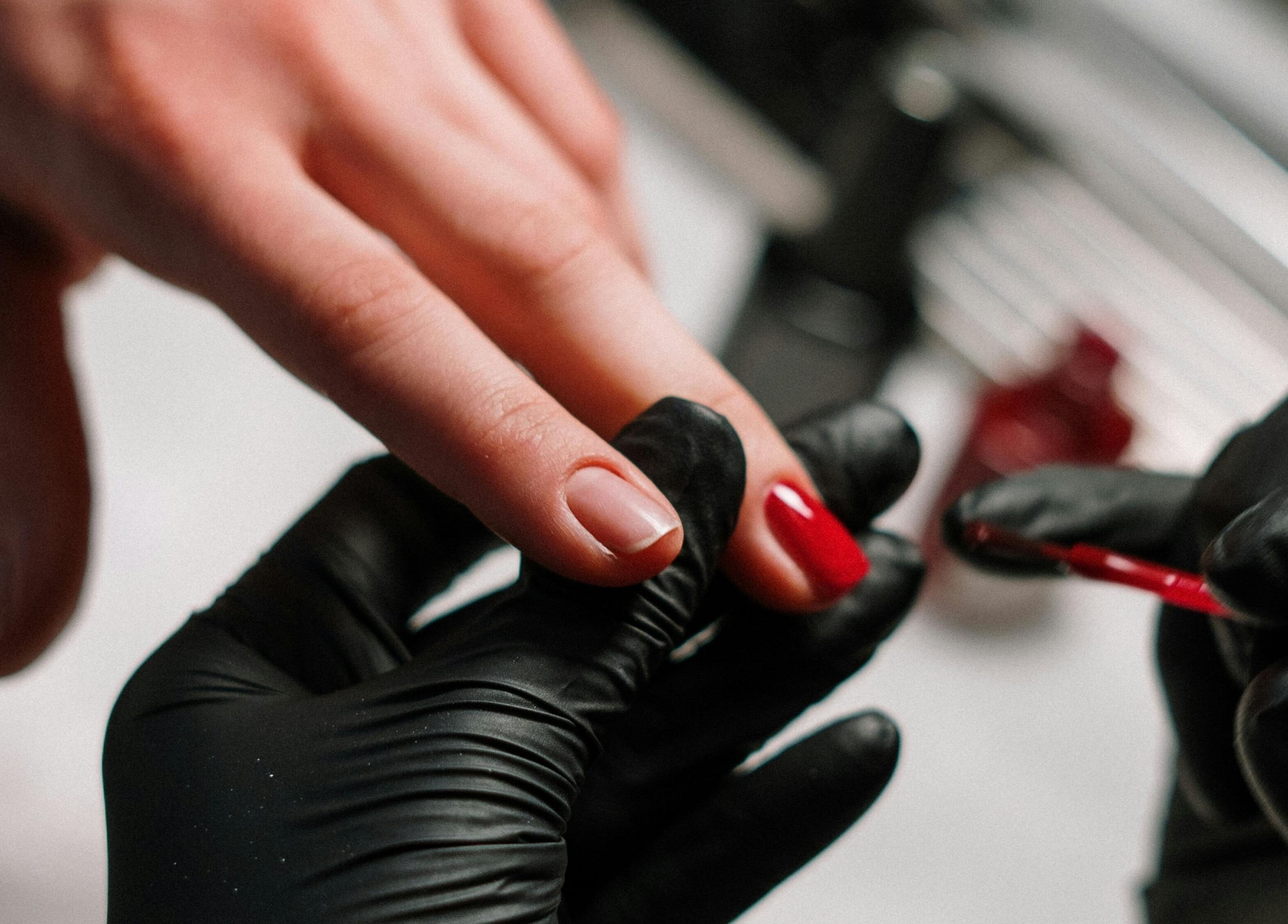 Luxurious manicure at Kulture Beauty Art in London, England, GB, showcasing red nail polish application.