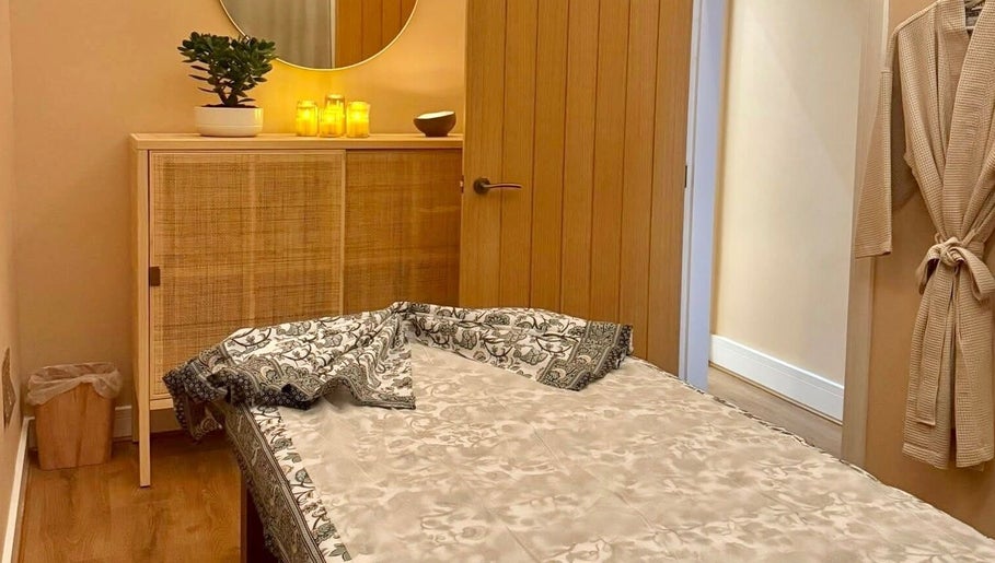 Cozy treatment room at Roukh Thai Wellness Prestwich, Prestwich, England, GB, with a massage table and warm lighting.