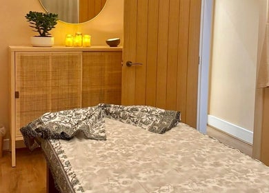Cozy treatment room at Roukh Thai Wellness Prestwich, Prestwich, England, GB, with a massage table and warm lighting.