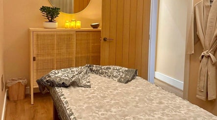 Cozy treatment room at Roukh Thai Wellness Prestwich, Prestwich, England, GB, with a massage table and warm lighting.