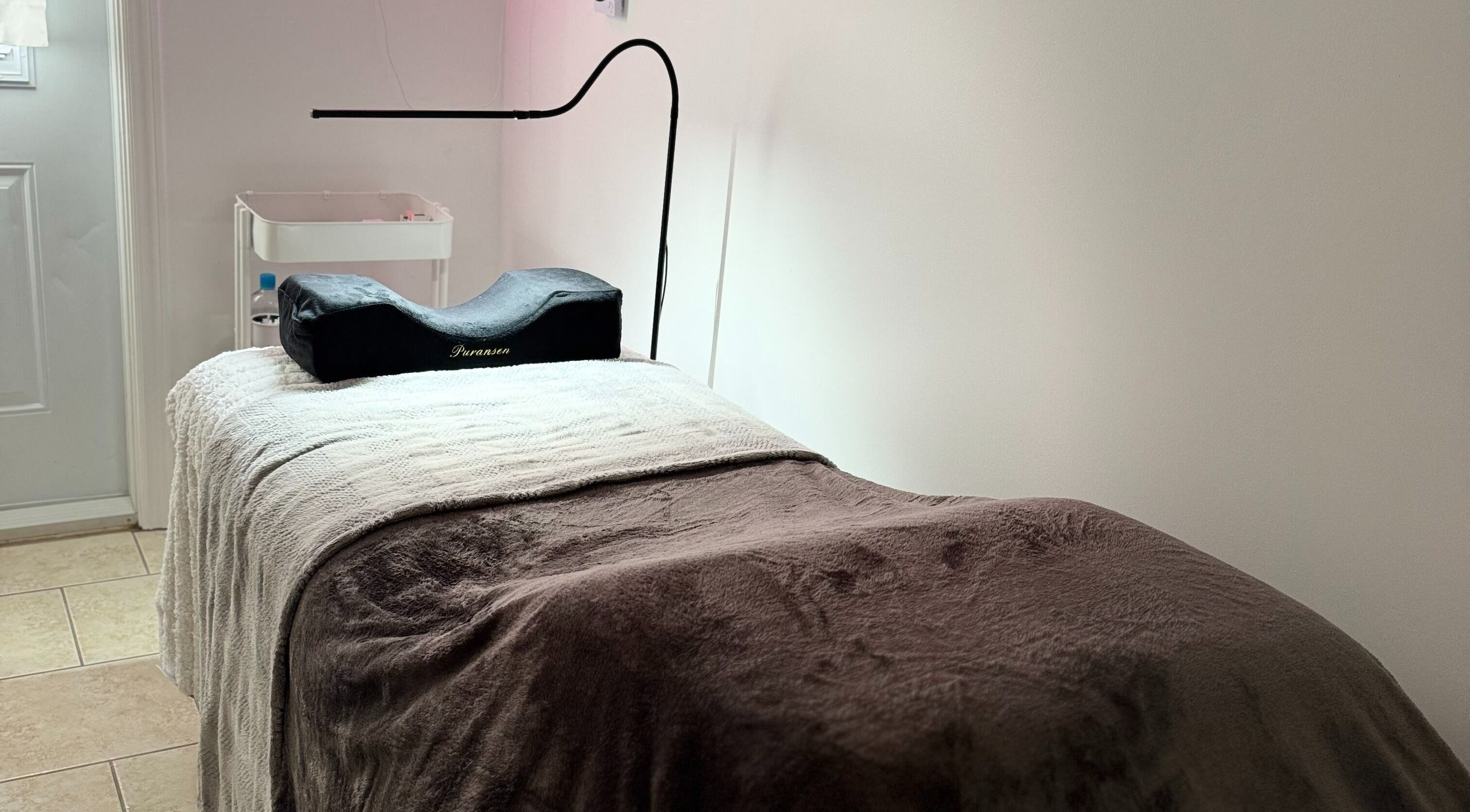 Elegant treatment bed at Lashes By Asia, Fall River, Nova Scotia, CA, inviting relaxation and comfort.