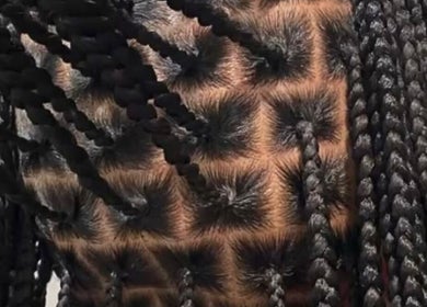 Detailed view of intricate braided hairstyle at DoneByZay, London, England, GB.