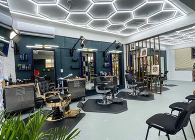 Modern interior of Fresh Again Self Care Studio in The Valley, AI with stylish barber chairs and sleek lighting.