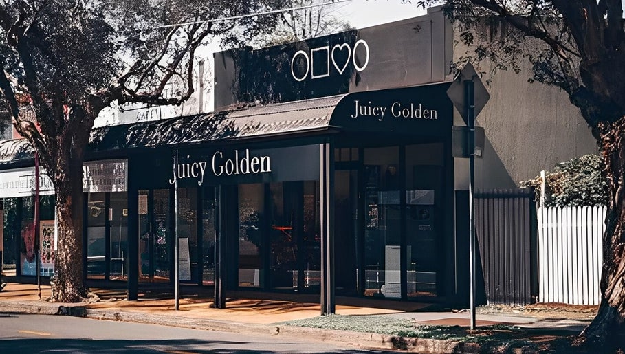 Street view of Juicy Golden beauty venue in Brisbane, Queensland, AU under leafy trees.