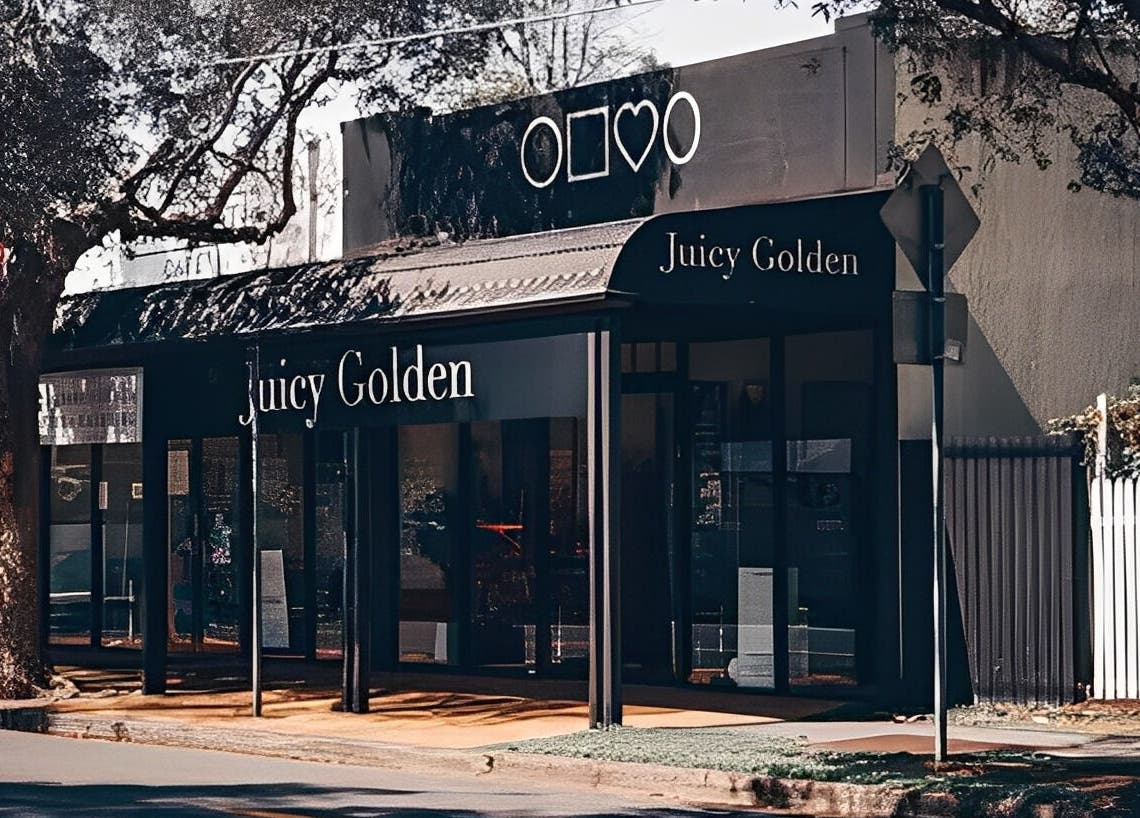 Street view of Juicy Golden beauty venue in Brisbane, Queensland, AU under leafy trees.