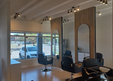 Elegant interior of Opalé Beauty Studio in Cape Town, Western Cape, ZA featuring sleek salon chairs and modern decor.