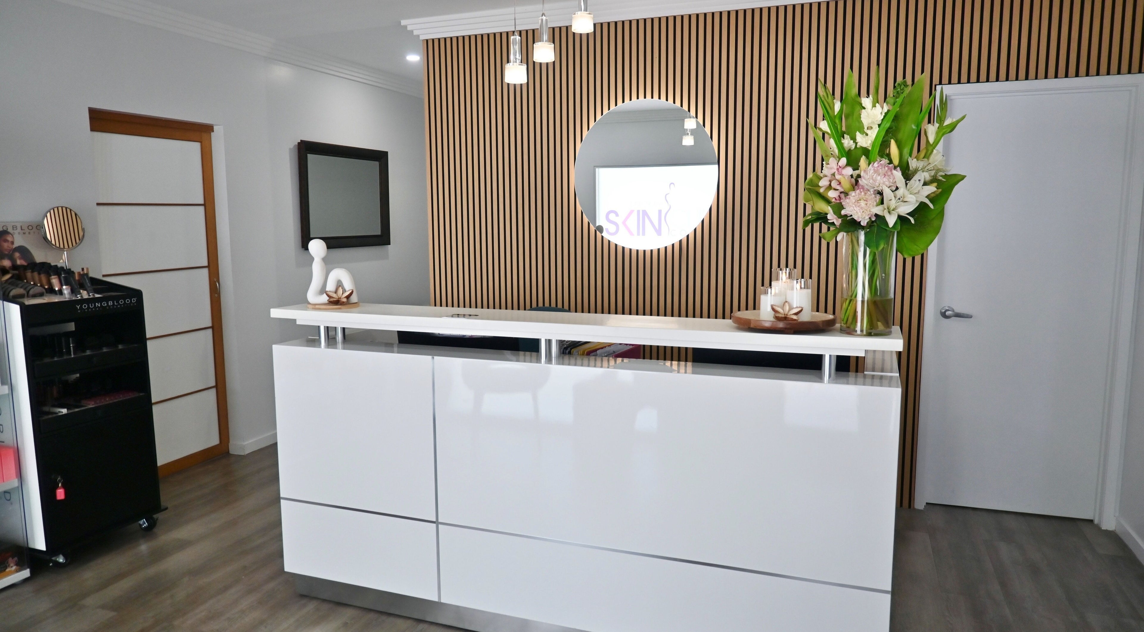 Sophisticated reception desk at Mackay Skin Clinic in North Mackay, Queensland, AU with floral arrangement.