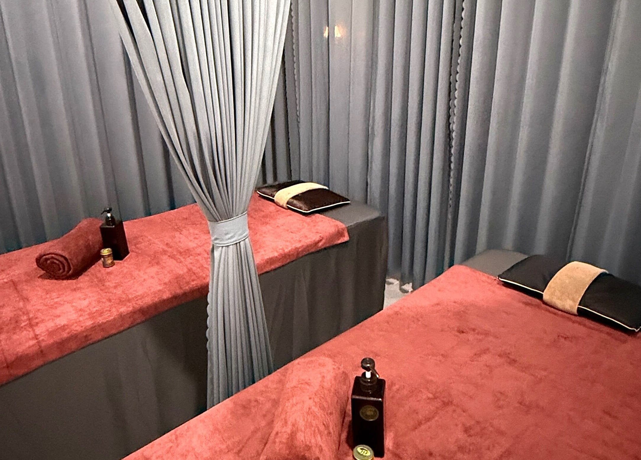 Relaxing massage beds at Senses Spa, Thành Phố Phú Quốc, Kiên Giang, VN, draped with soft red linens.