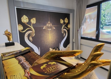 Interior of Changthai Massage in Bellinzona, Ticino, CH with gold decor and serene atmosphere.