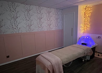 Relaxing massage room at Cherry Blossom Spa in Leyland, England, GB, featuring calming floral decor and soft lighting.