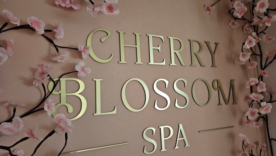 Cherry Blossom Spa sign with pink blossoms in Leyland, England, GB, exuding elegance and tranquility.
