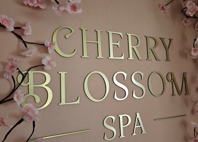 Cherry Blossom Spa sign with pink blossoms in Leyland, England, GB, exuding elegance and tranquility.