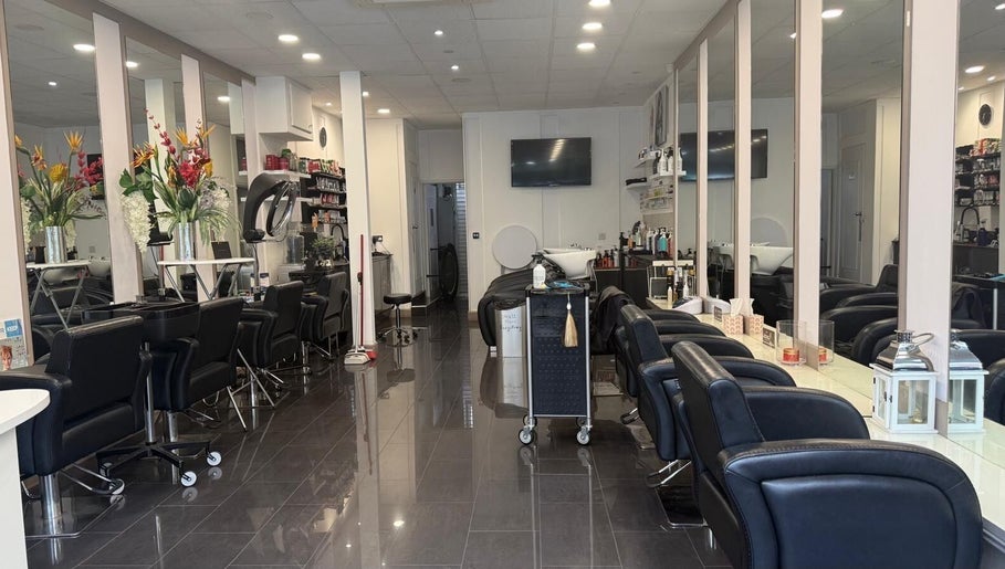 Adelle hairdresser salon interior in London, England, GB, featuring stylish chairs and mirrors.