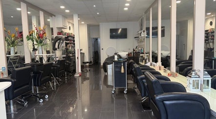 Adelle hairdresser salon interior in London, England, GB, featuring stylish chairs and mirrors.