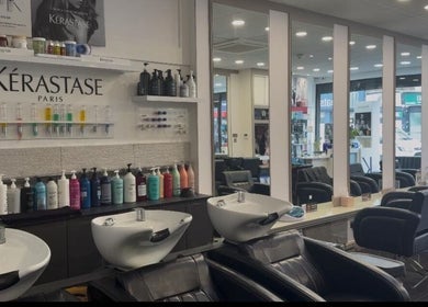 Interior of Adelle hairdresser, London, England, GB, showcasing modern styling stations and luxury products.