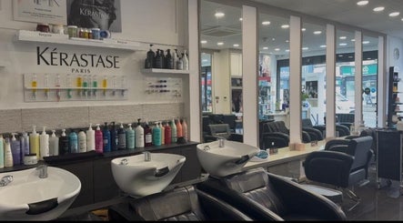 Interior of Adelle hairdresser, London, England, GB, showcasing modern styling stations and luxury products.