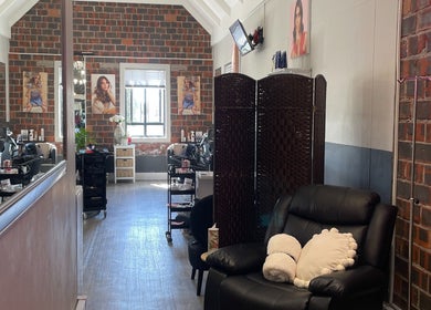 Cozy salon interior at Hair by Tess, Cape Town, Western Cape, ZA, with sleek decor and plush seating.
