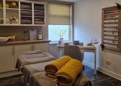 Relaxing interior of Helow Beauty Blackpool featuring treatment beds and cozy towels in Blackpool, England, GB.