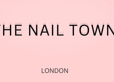 THE NAIL TOWN salon signage in London, England, GB on a soft pink background.