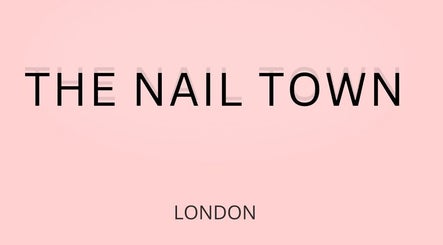 THE NAIL TOWN salon signage in London, England, GB on a soft pink background.
