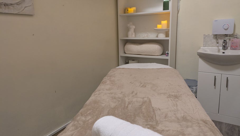 Peaceful massage room at Chioma Beauty and Bodywork in London, England, GB with soft lighting and cozy decor.