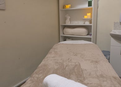Peaceful massage room at Chioma Beauty and Bodywork in London, England, GB with soft lighting and cozy decor.
