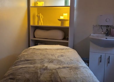 Relaxation room at Chioma Beauty and Bodywork, London, England, GB with calm lighting and a comfortable massage bed.