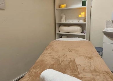 Cozy massage room at Chioma Beauty and Bodywork, London, England, GB, featuring a comfortable massage table.