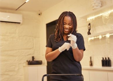 Smiling staff at IVVI, Lekki, Lagos, NG preparing for a beauty treatment.