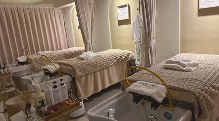 REE SPA treatment room with beds and robes in New York, New York, US, offering ultimate relaxation.