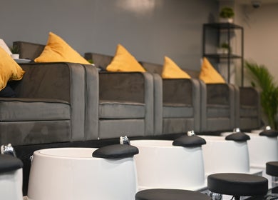Pedicure lounge at REE SPA, New York, New York, US featuring cozy chairs and foot baths.