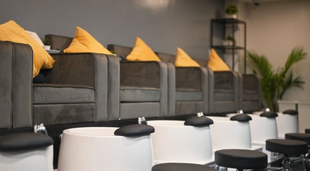 Pedicure lounge at REE SPA, New York, New York, US featuring cozy chairs and foot baths.