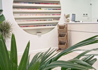 Bright reception with nail polish display at REE SPA, New York, New York, US, enhanced by lush greenery.