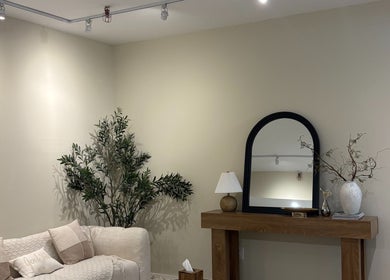 Elegant REE SPA lounge in New York, New York, US with cozy seating, mirror, and plants.