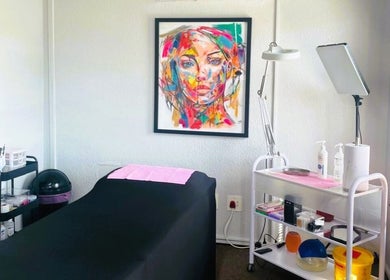 Colorful treatment room at OCD Permanent MakeUp, Krugersdorp, Gauteng, ZA with art and supplies.