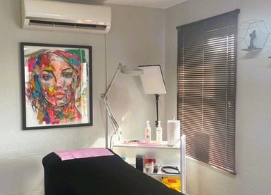 Cozy treatment room at OCD Permanent MakeUp, Krugersdorp, Gauteng, ZA, featuring vibrant art and modern equipment.
