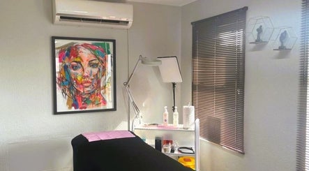 Cozy treatment room at OCD Permanent MakeUp, Krugersdorp, Gauteng, ZA, featuring vibrant art and modern equipment.