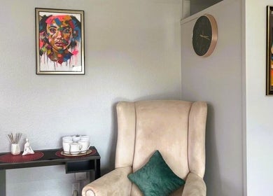 Cozy seating area with colorful art at OCD Permanent MakeUp in Krugersdorp, Gauteng, ZA.