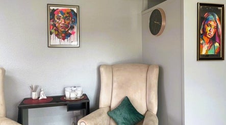Cozy seating area with colorful art at OCD Permanent MakeUp in Krugersdorp, Gauteng, ZA.