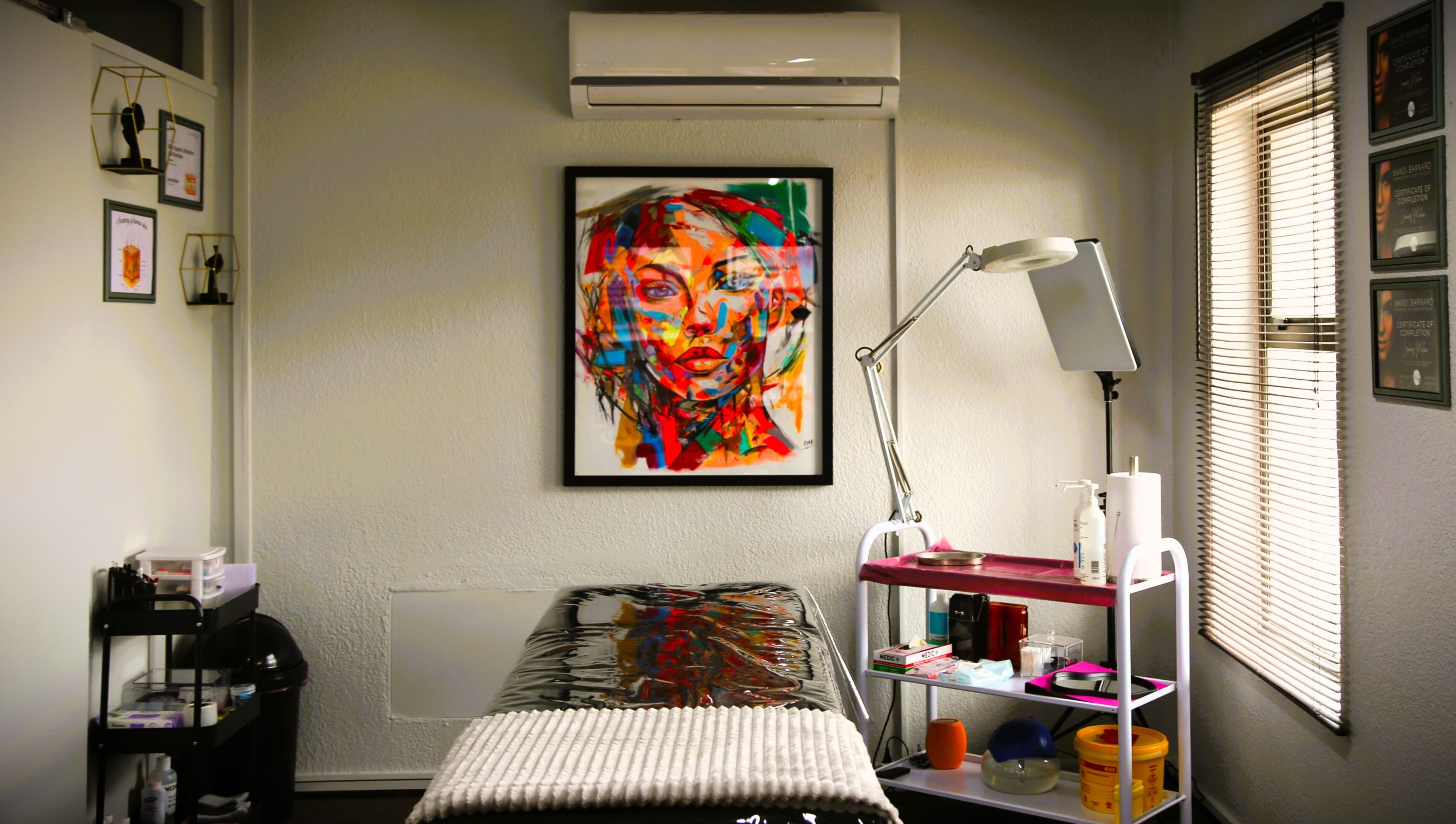 Inviting treatment room at OCD Permanent MakeUp, Krugersdorp, Gauteng, ZA, featuring vibrant wall art.