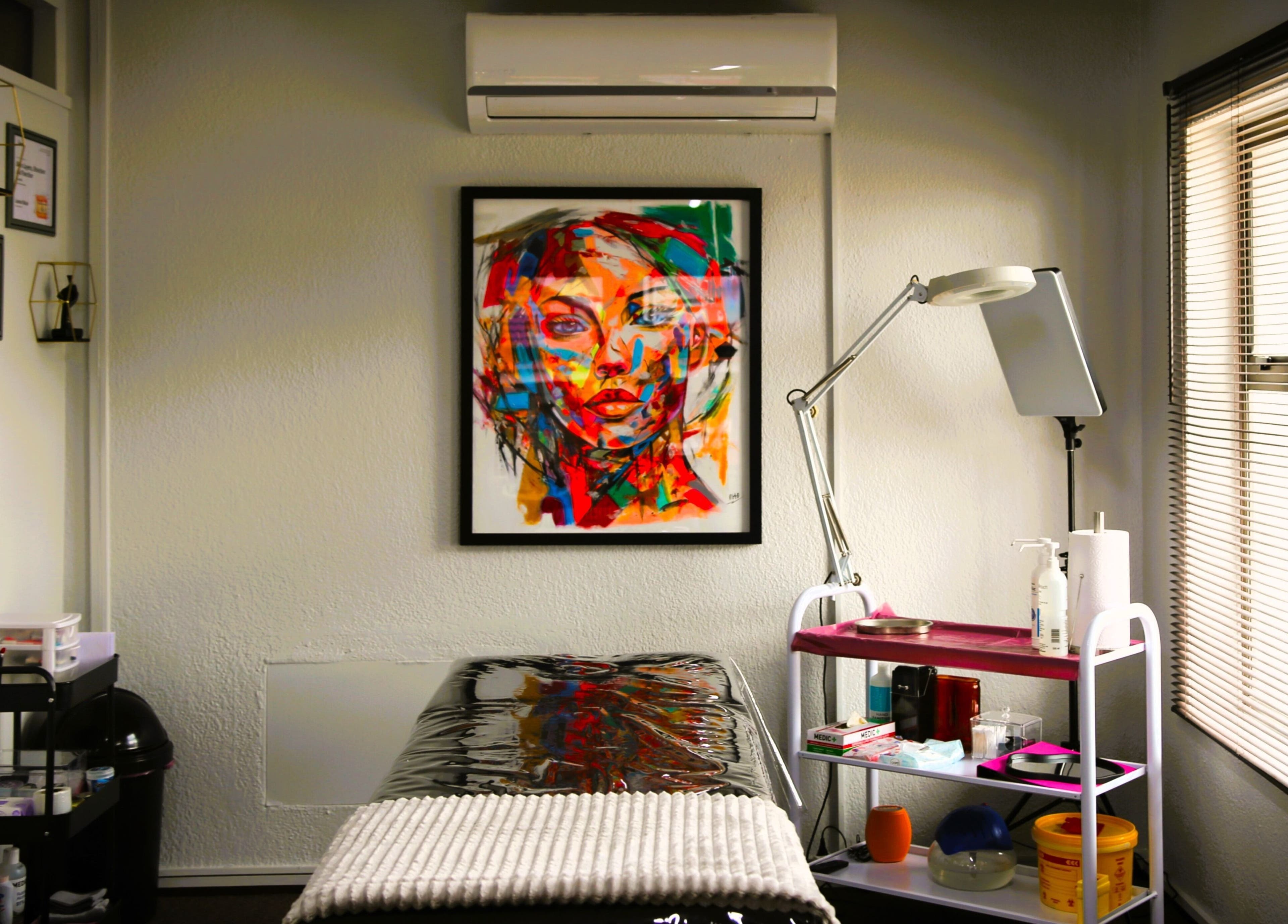 Inviting treatment room at OCD Permanent MakeUp, Krugersdorp, Gauteng, ZA, featuring vibrant wall art.